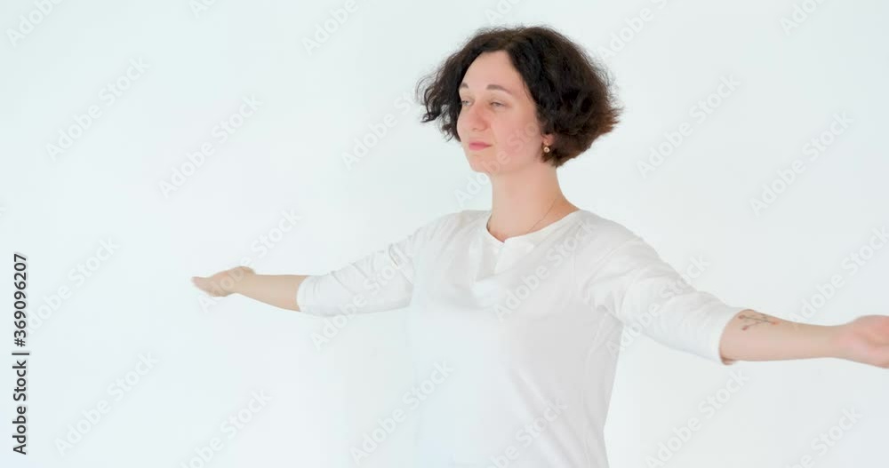 woman practicing qi qong at white studio traditional chinese gymnastics woman practicing qi qong at white studio traditional chinese gymnastics
