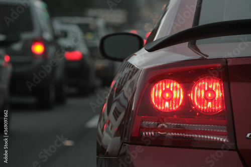 A red car with it's brake lights on sits in traffic on highway 280 in Birmingham Alabama