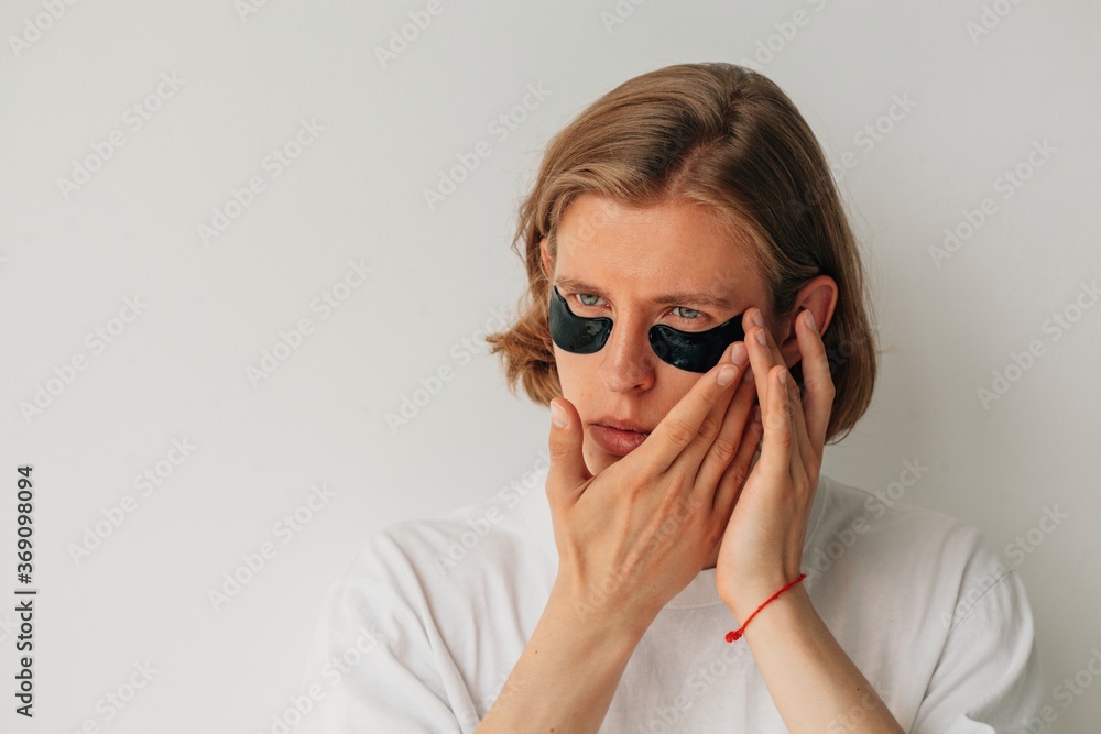 Young blond man with black eye patches Young blond man with black eye patches