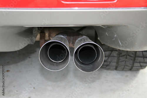 Canvas Print Two exhaust pipes extend out the back of a car