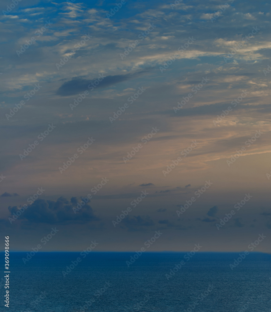 Calm Sea Ocean And Blue Sky Background. Beautiful seascape at Sunset.