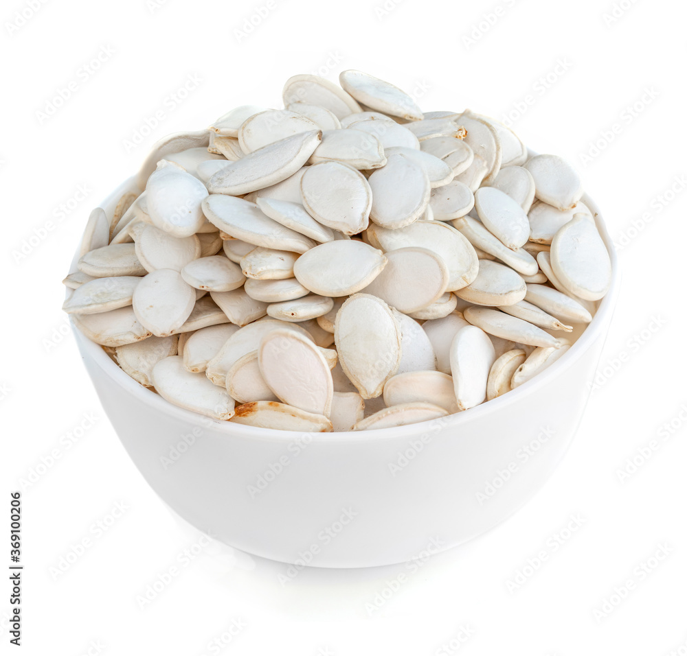 Pumpkin seeds in a bowl isolated on white background. Pumpkin seeds in a bowl isolated on white background.