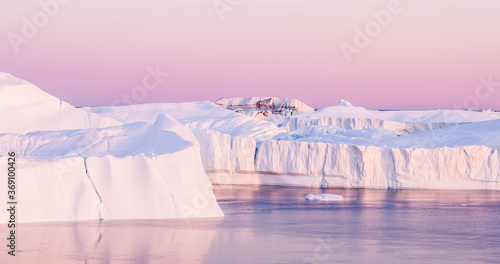Climate Change. Iceberg and ice from glacier in arctic nature landscape on Greenland. Aerial image drone footage of icebergs in Ilulissat icefjord. famously affected by and global warming. photo