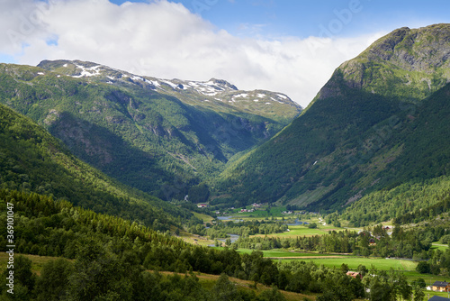 Small farms with green fields amongst the Norwegian high mountains, close to Hemsedal