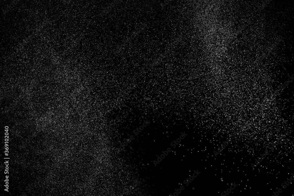 Abstract splashes of water on black background. Freeze motion of white particles. Rain, snow overlay texture. Abstract splashes of water on black background. Freeze motion of white particles. Rain, snow overlay texture.