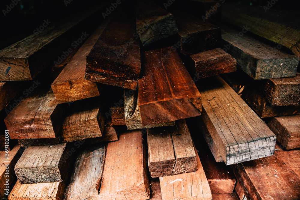Pile of new wooden bars at construction site. Wood timber construction material texture. Stack of old lumbers. Pile of new wooden bars at construction site. Wood timber construction material texture. Stack of old lumbers.