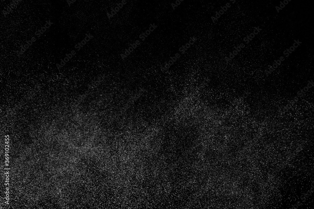 Fototapeta premium Abstract splashes of water on black background. Freeze motion of white particles. Rain, snow overlay texture.