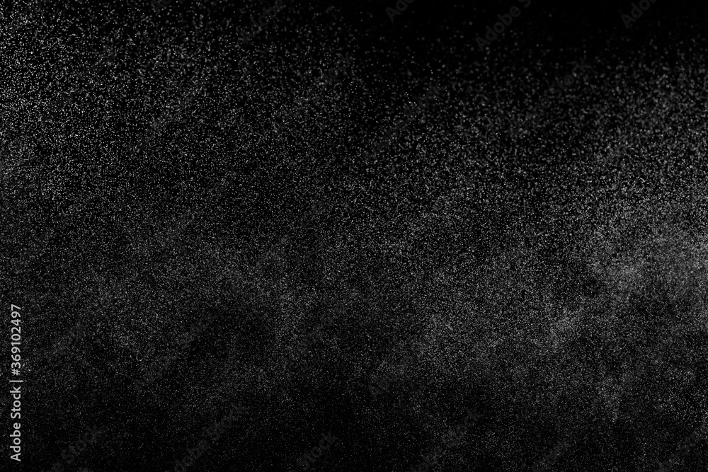 Abstract splashes of water on black background. Freeze motion of white particles. Rain, snow overlay texture. Abstract splashes of water on black background. Freeze motion of white particles. Rain, snow overlay texture.
