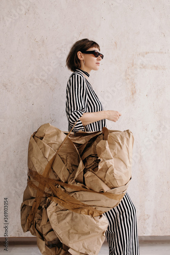 Confident artistic woman carrying abstract baggage photo
