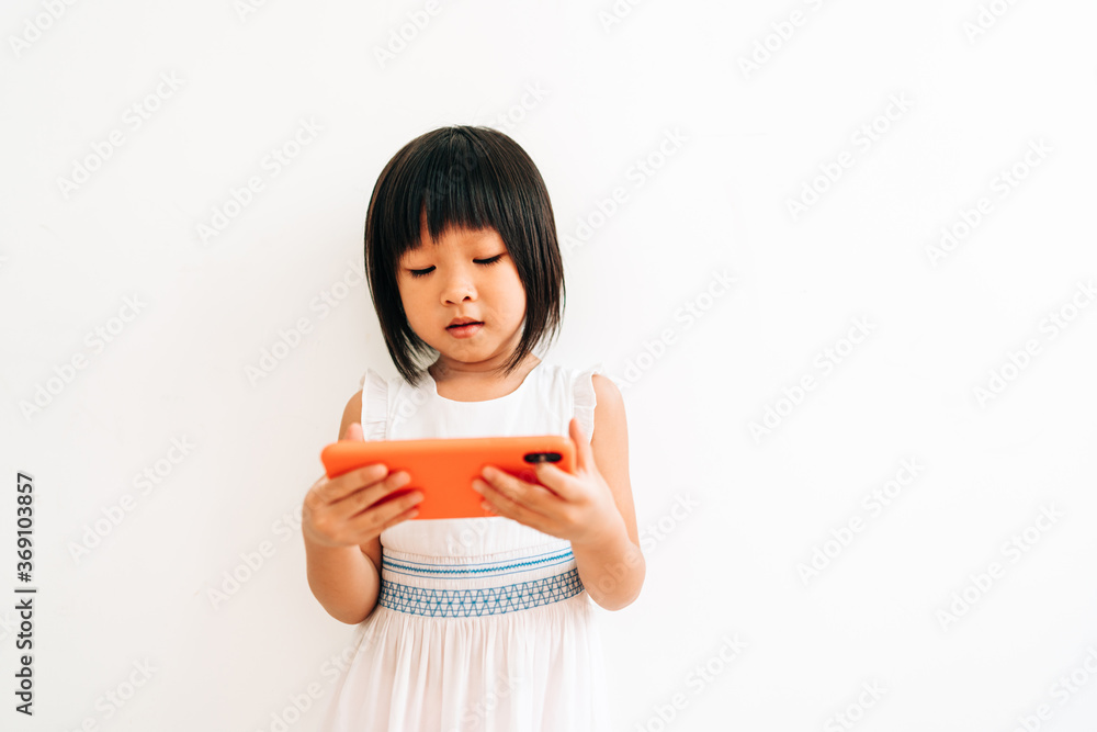 portrait of little girl using cell phone portrait of little girl using cell phone