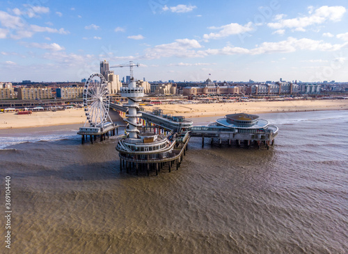 Quadro em tela Pier with Ferris Wheel at Northern Sea Scheveningen Beach , located near the Hague city aerial drone footage