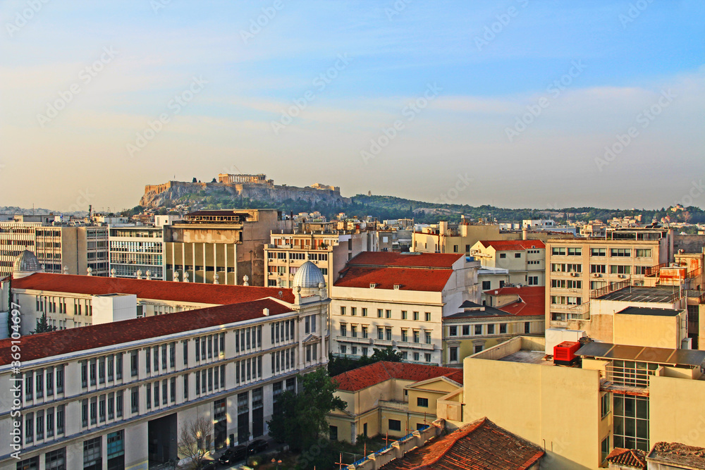 Ariel view of the Acropolis and Business District of Athens, Greece with red roofs and blue sky copy space.