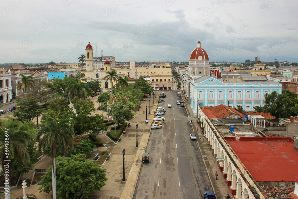 View of City Hall, park and downtown in Cienfuegos on the southern coast of Cuba. Urban street Caribbean city scene.UNESCO site with colorful colonial houses.