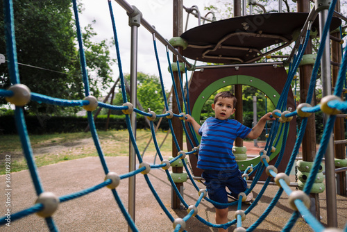 Boy in casual clothes going thorough toy grid