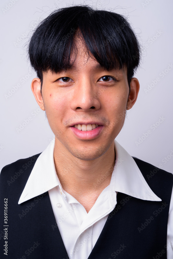 Portrait of happy young handsome Asian businessman Portrait of happy young handsome Asian businessman