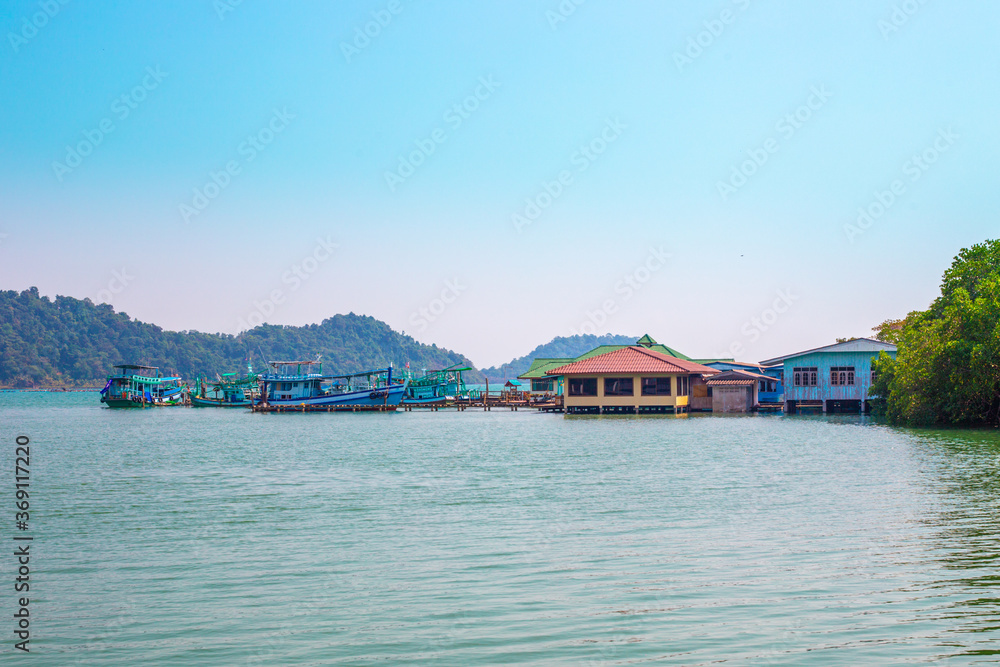 Naklejka premium A pier in a fishing Thai village. Summer vacation on a tropical island. Infrastructure on Koh Chang in Thailand