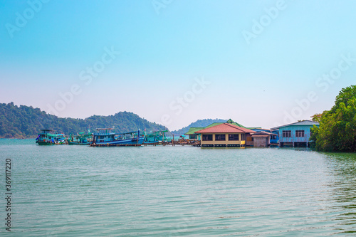 A pier in a fishing Thai village. Summer vacation on a tropical island. Infrastructure on Koh Chang in Thailand