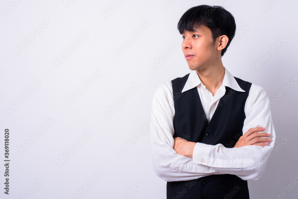 Portrait of young handsome Asian businessman against white background Portrait of young handsome Asian businessman against white background
