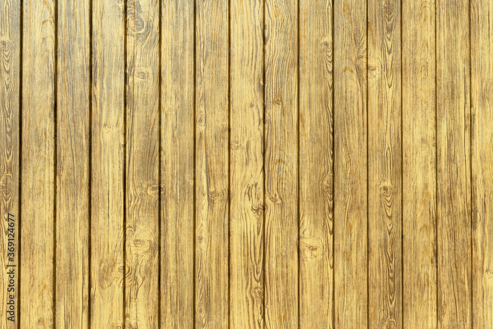 Fototapeta premium The wall is sheathed with vertical wooden planks.