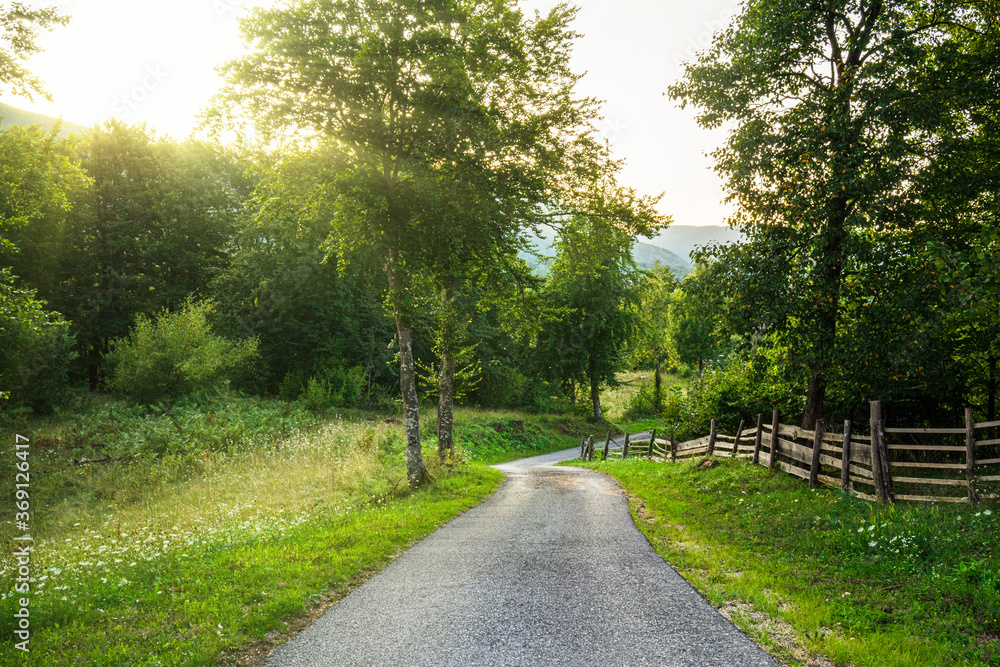 Rural Road Winding its Way Down a Hill Rural Road Winding its Way Down a Hill
