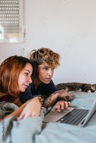 Lesbian couple using computer. photo