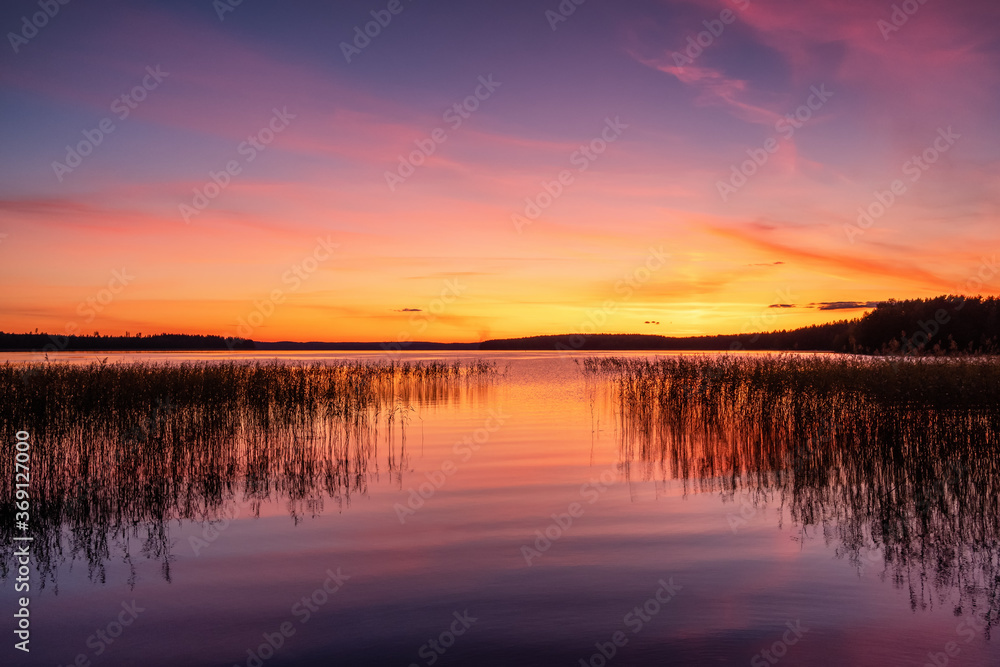 Stunning sunset sky over the calm lake water