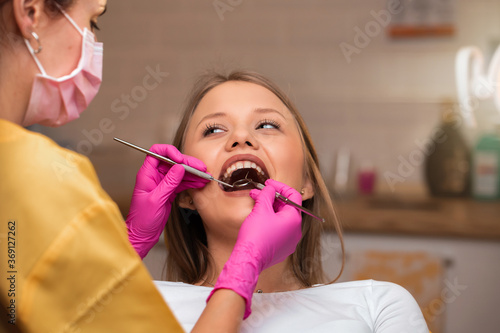 Beautiful young blonde women at dentist for examination