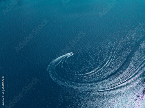 Aerial drone view of speed boat in motion, transportation concept, summer time.