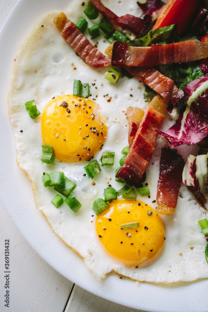 Fried eggs with bacon and salad Fried eggs with bacon and salad