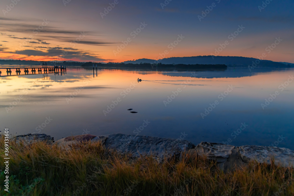 Clouds, reflections and sunrise over the bay Clouds, reflections and sunrise over the bay