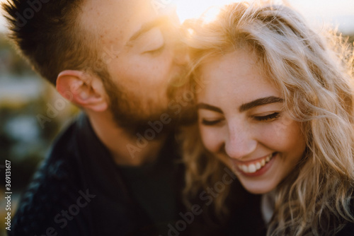 Happy couple in love at sunset photo