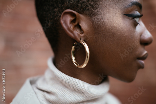 Black woman with shiny earring photo