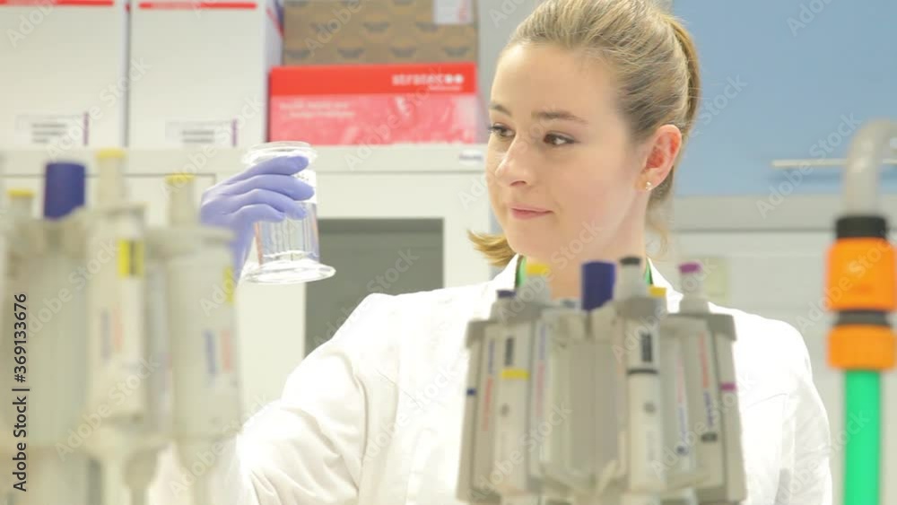 Young Lady Scientists Testing Samples And Experimenting In a Laboratory Young Lady Scientists Testing Samples And Experimenting In a Laboratory