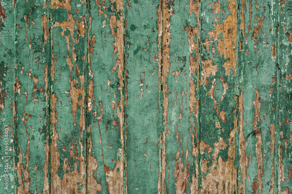 Old wood wall with green paint peeling and chipping away. Old wood wall with green paint peeling and chipping away.