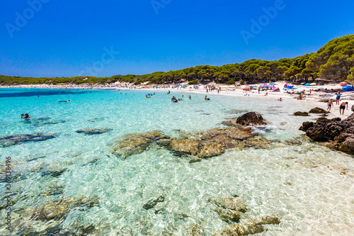 Fototapeta Naklejka Na Ścianę i Meble -  CALA AGULLA, MALLORCA, SPAIN - 21 July 2020: People enjoying summer on the popular beach on Mallorca,  Balearic Islands.