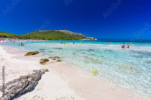 CALA AGULLA, MALLORCA, SPAIN - 21 July 2020: People enjoying summer on the popular beach on Mallorca,  Balearic Islands. photo