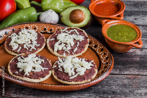 Mexican sopes with grated cheese and fried beans, Traditional breakfast in Mexico © Marcos