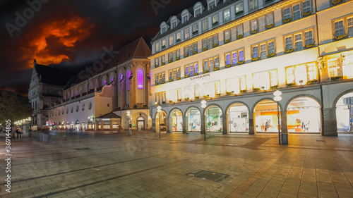 Exterior view of Hirmer, the largest men's fashion house in the world during nigh photo