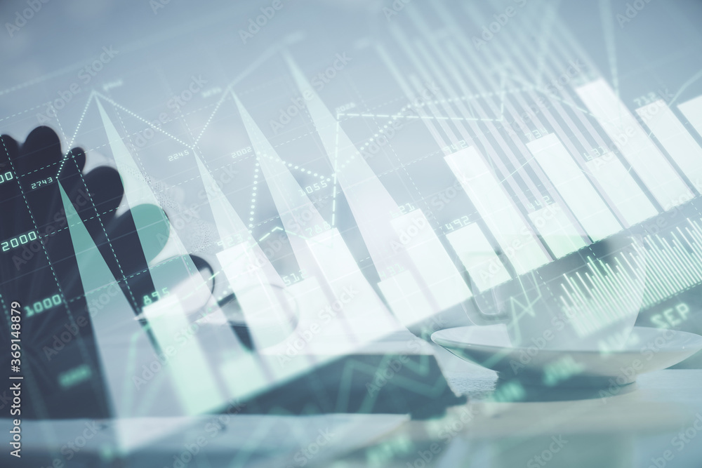 Double exposure of financial chart drawing and desktop with coffee and items on table background. Concept of forex market trading Double exposure of financial chart drawing and desktop with coffee and items on table background. Concept of forex market trading