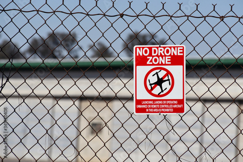 No drone signed on chain-link fence near airport