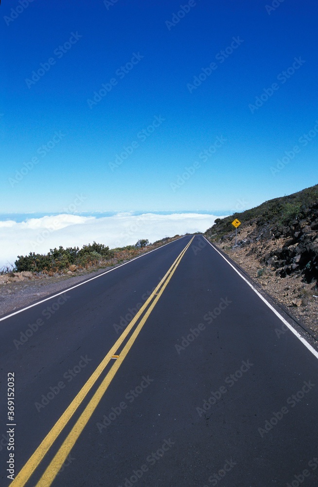 ROAD IN HAWAI GOING TO CLOUDS AND BLUE SKY ROAD IN HAWAI GOING TO CLOUDS AND BLUE SKY