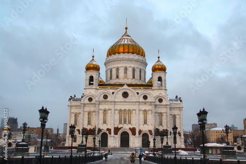 Beautiful Cathedral Christ the Saviour, white and golden in sunrise morning with beautiful blue, yellow and orange colors in the winter, snow, Moscow, Russia.