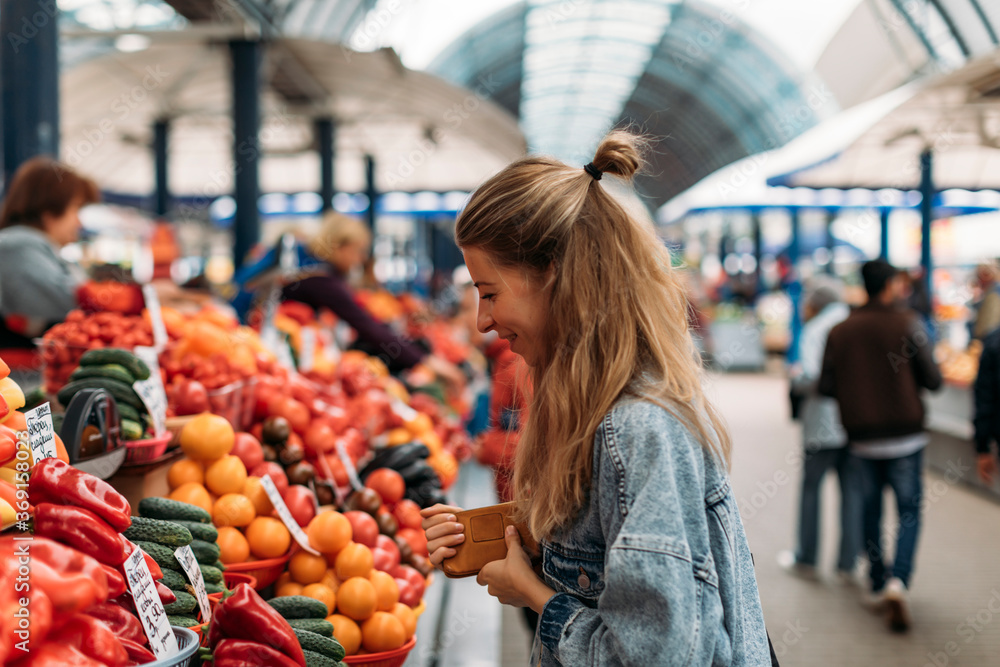 Woman buying fruits and vegetables on the market. Woman buying fruits and vegetables on the market.