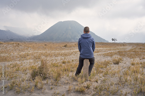 Man visiting Bromo volcano and taking a break. photo