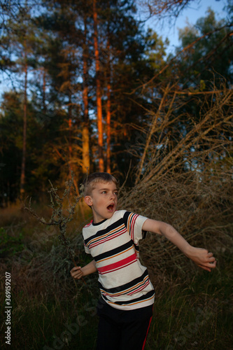 A boy plays expressively at dusk in rural Finland. photo