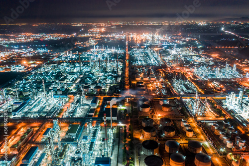 Aerial view oil and gas tank with oil refinery background at night