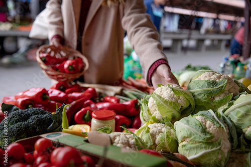 Autumn fresh produce - woman buying fresh vegetables at farmers market photo