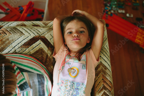 girl makes silly faces on couch