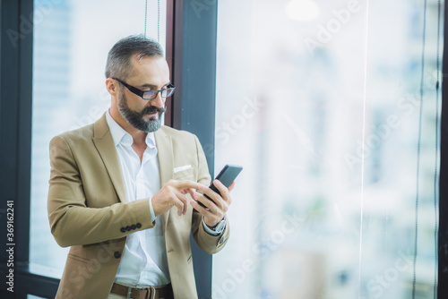 portrait of bearded gentleman wearing trendy suit, moustache businessman