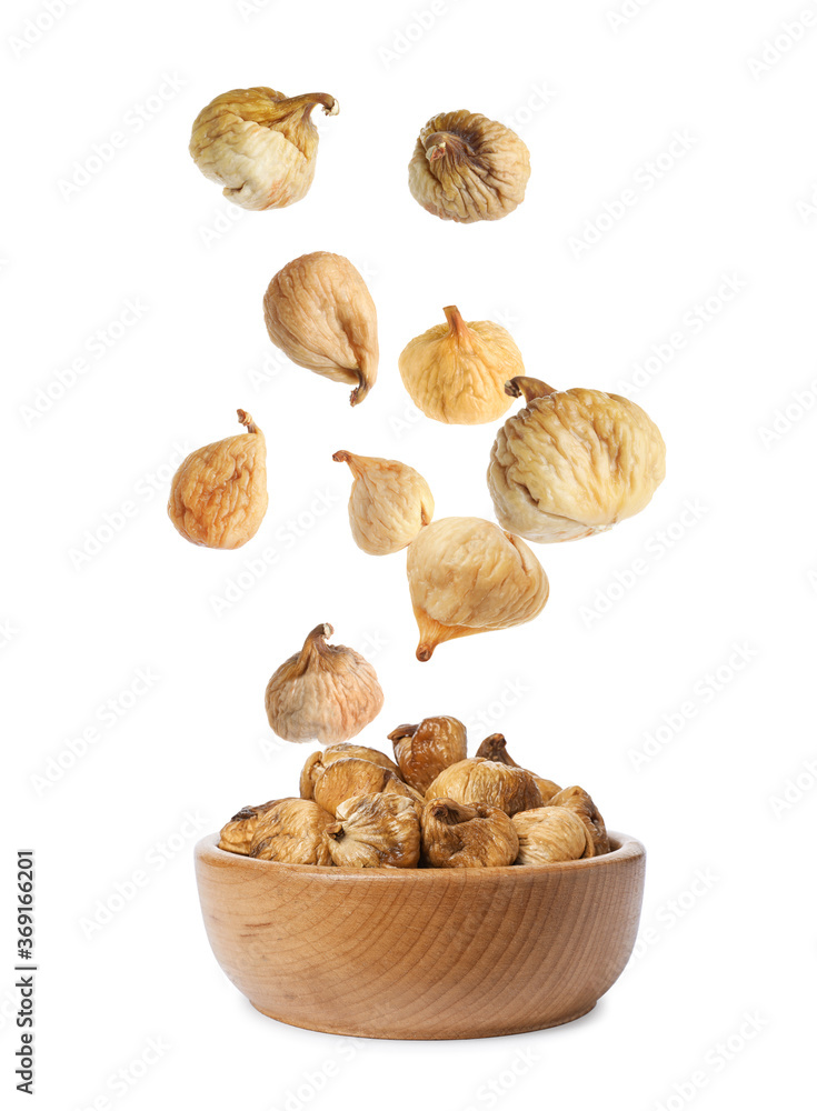 Dried fig fruits falling into bowl on white background Dried fig fruits falling into bowl on white background